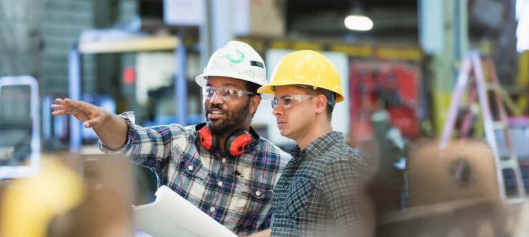 Two workers with construction helmets