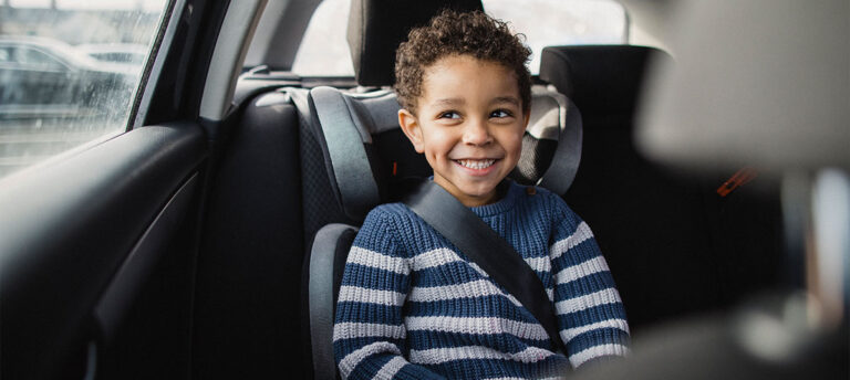 A young child securely buckled in a car seat, highlighting the importance of car seat safety.