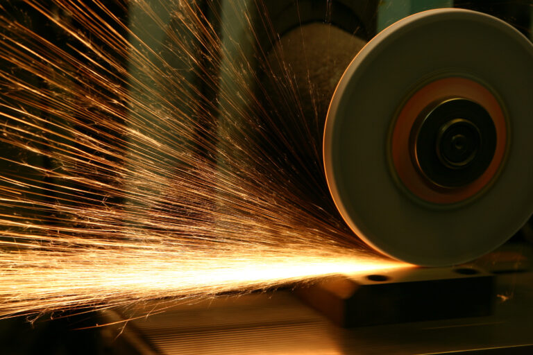 Industrial grinder in operation, highlighting the importance of managing liability risks in manufacturing processes