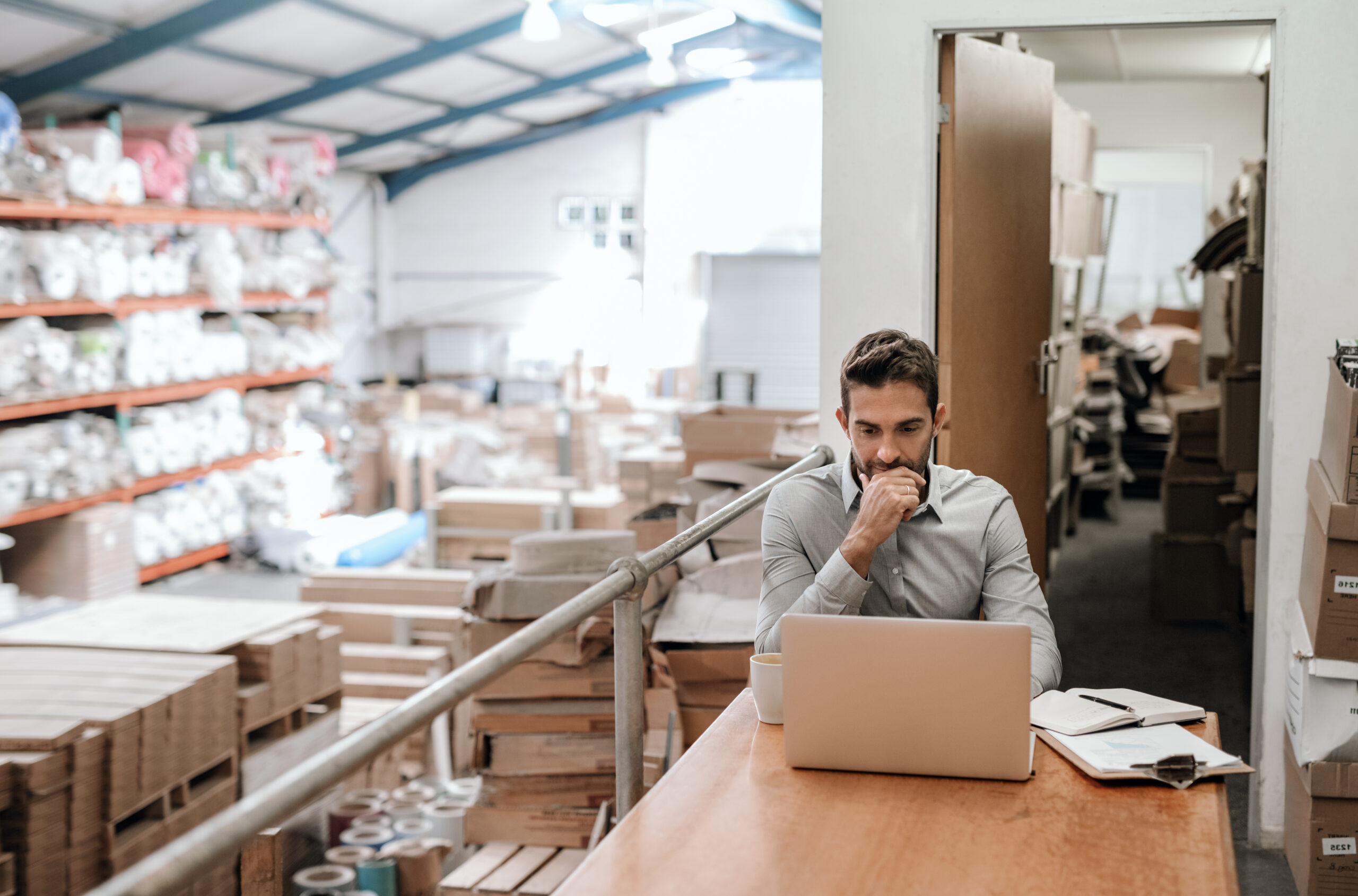 Manufacturing manager reviewing equipment maintenance schedules and implementing a preventative maintenance plan in a factory.