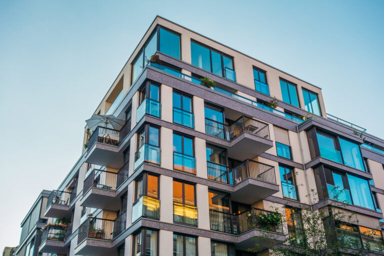 Modern condo building with large windows, highlighting the importance of condo insurance for protection.